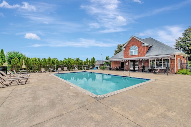 view of swimming pool with a patio