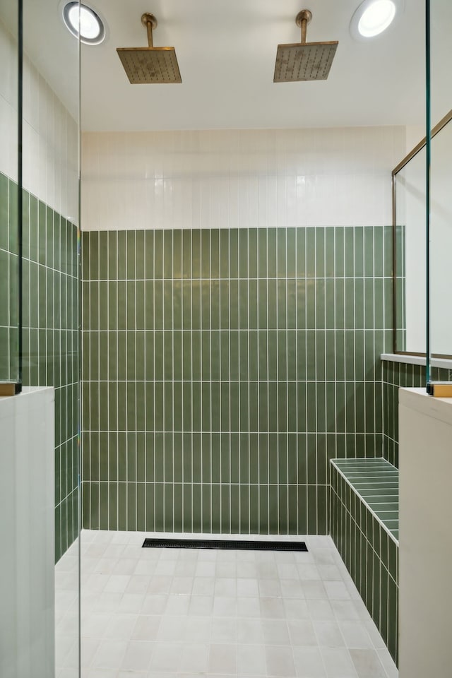 bathroom with a shower and tile walls