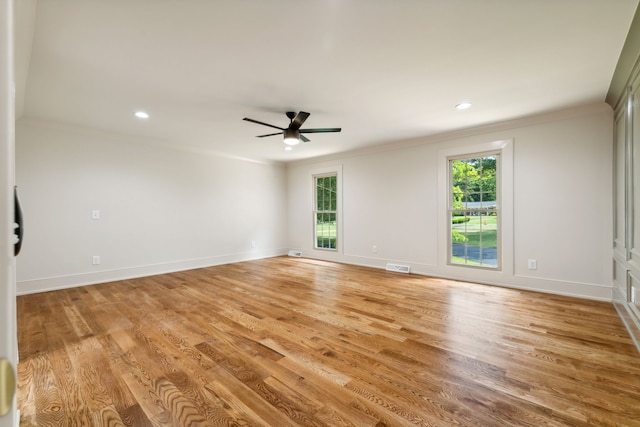 unfurnished room featuring ceiling fan, light wood-type flooring, and crown molding