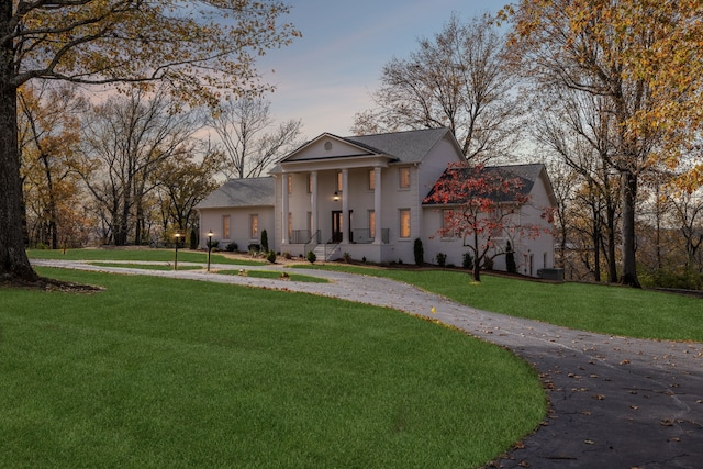 greek revival inspired property with a yard