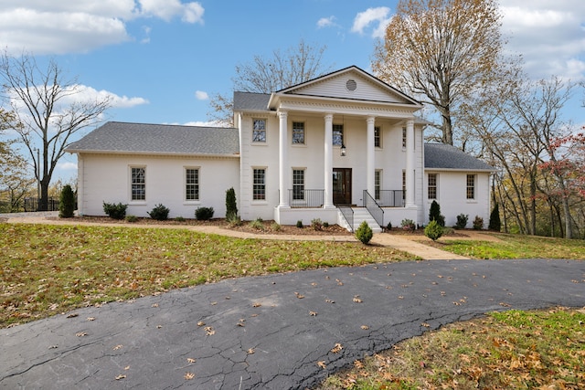 neoclassical / greek revival house with a porch and a front yard