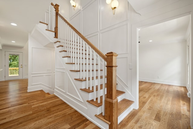 stairs featuring hardwood / wood-style floors