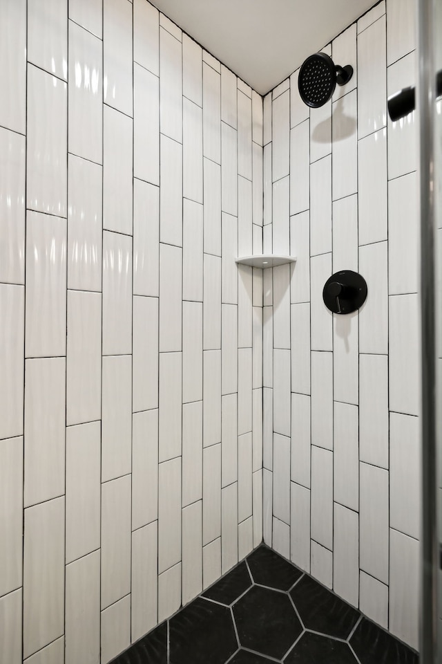 bathroom with a tile shower