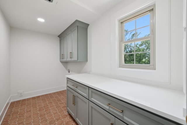 laundry area with cabinets