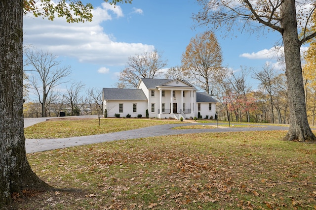 neoclassical / greek revival house with a front lawn and covered porch