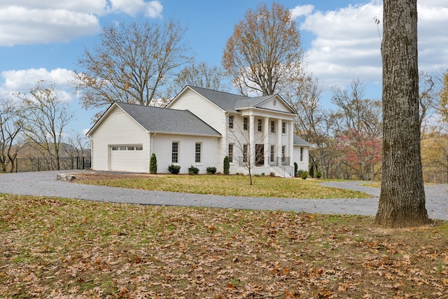 view of front facade with a front lawn and a garage