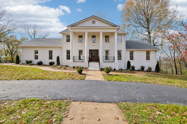 greek revival inspired property featuring covered porch