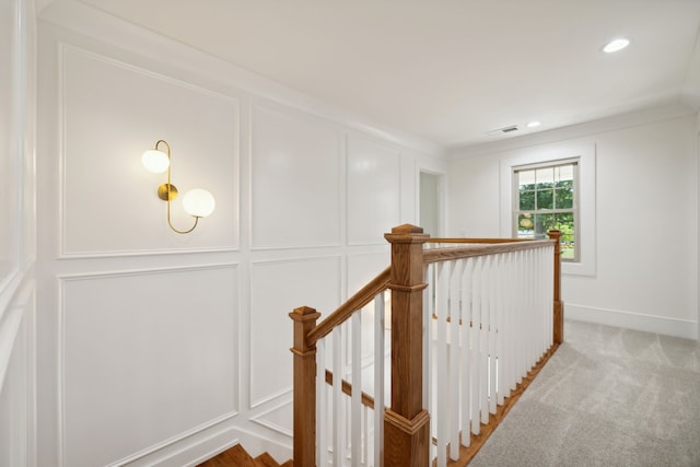 staircase featuring carpet and crown molding