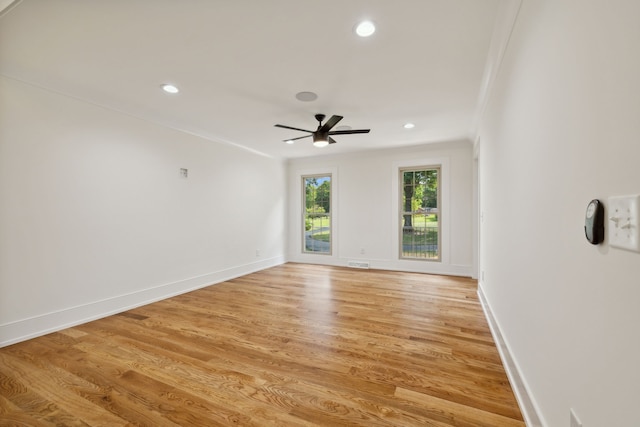 empty room with light hardwood / wood-style flooring, ceiling fan, and crown molding