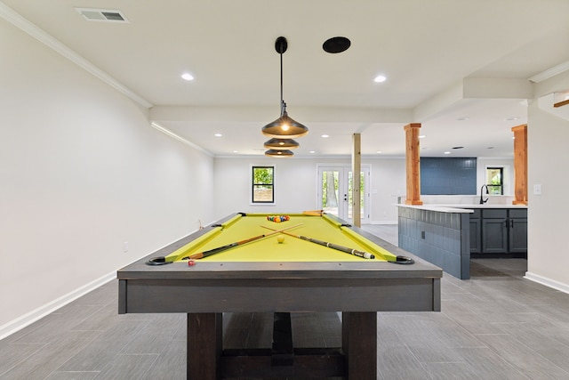 recreation room with decorative columns, crown molding, sink, and billiards