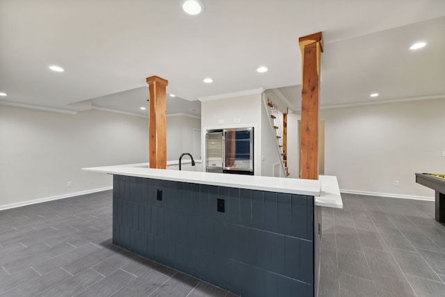 kitchen featuring dark hardwood / wood-style flooring, a spacious island, ornamental molding, and high quality fridge