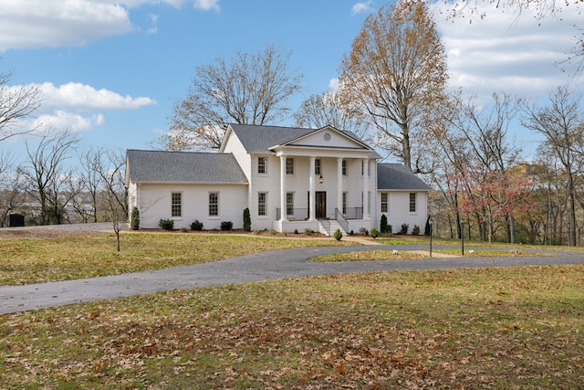 greek revival house with a front yard