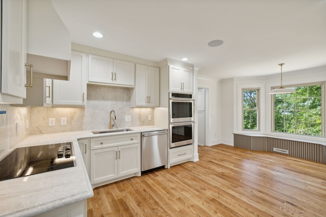 kitchen with white cabinetry, sink, and appliances with stainless steel finishes