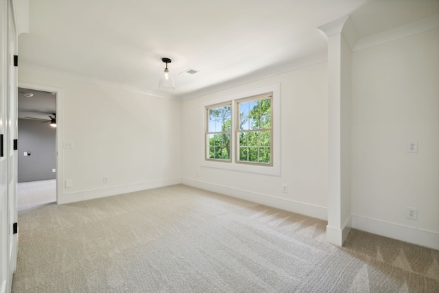 carpeted empty room with ceiling fan and ornamental molding