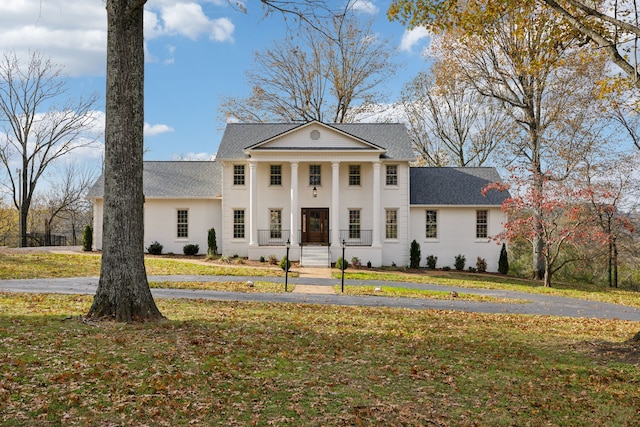 greek revival house with a front yard