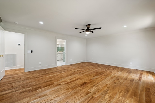 empty room featuring ceiling fan, crown molding, and light hardwood / wood-style floors