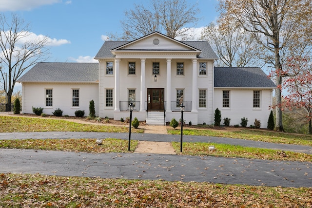 neoclassical / greek revival house featuring a front lawn