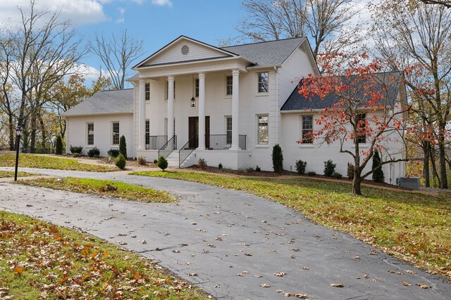 neoclassical / greek revival house with a front lawn