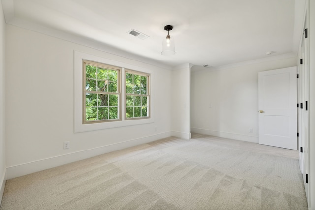 carpeted spare room with crown molding