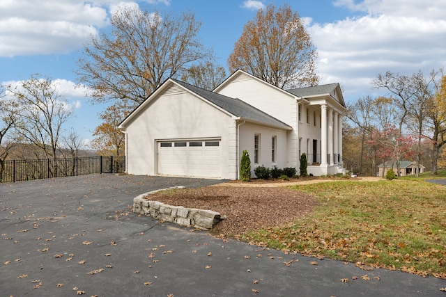 view of side of property with a garage