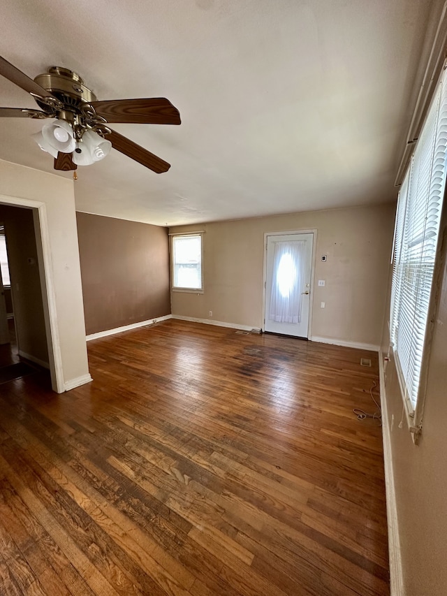 unfurnished living room with ceiling fan and dark hardwood / wood-style floors