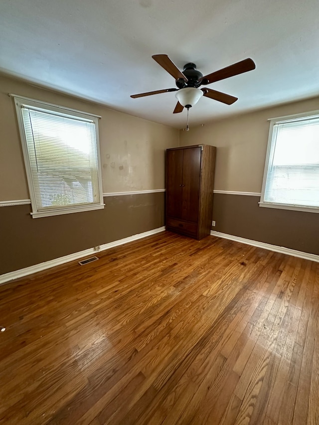 unfurnished bedroom featuring ceiling fan and hardwood / wood-style flooring