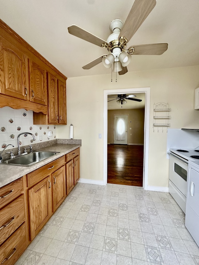 kitchen featuring ceiling fan, sink, tasteful backsplash, white range with electric stovetop, and light wood-type flooring