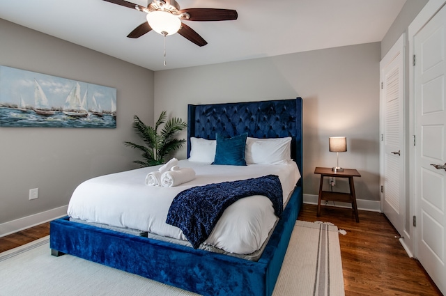 bedroom with ceiling fan and dark wood-type flooring