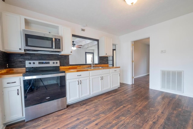 kitchen with white cabinetry, sink, wooden counters, decorative backsplash, and appliances with stainless steel finishes