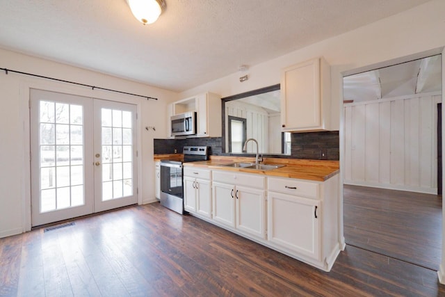 kitchen featuring dark wood-type flooring, white cabinetry, sink, and stainless steel appliances