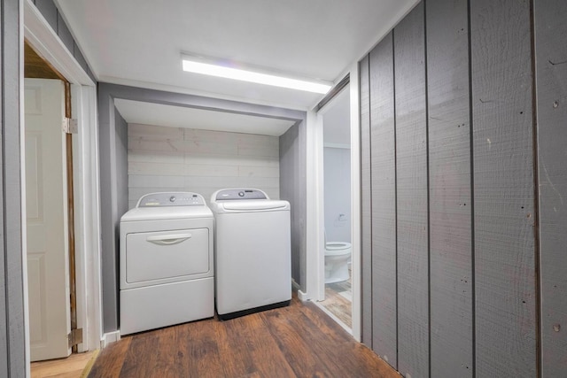 washroom with dark hardwood / wood-style floors and washer and dryer