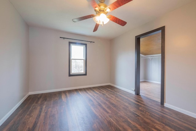 spare room with ceiling fan and dark hardwood / wood-style flooring