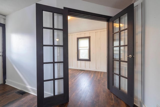 foyer featuring dark hardwood / wood-style flooring, french doors, and lofted ceiling