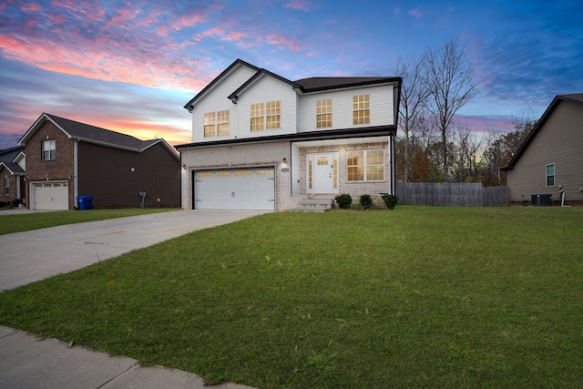 front of property featuring a garage, cooling unit, and a lawn