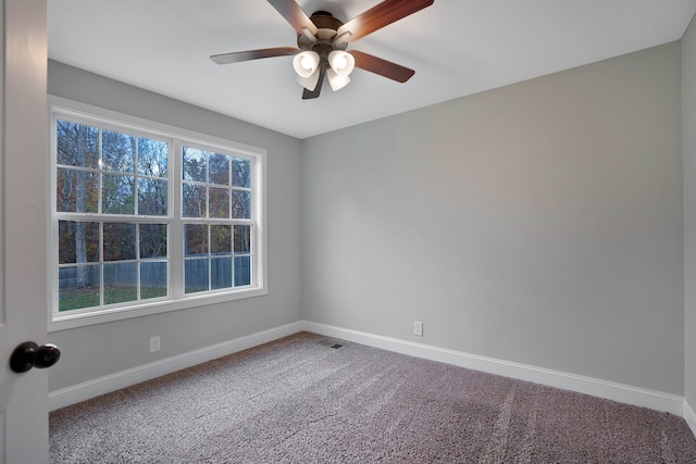 carpeted empty room featuring ceiling fan