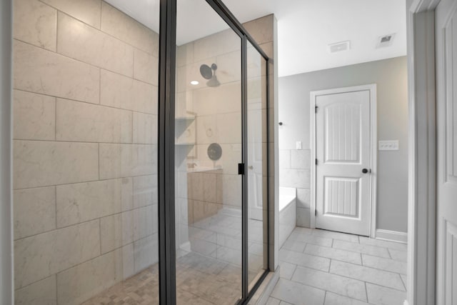 bathroom featuring tile patterned flooring and plus walk in shower