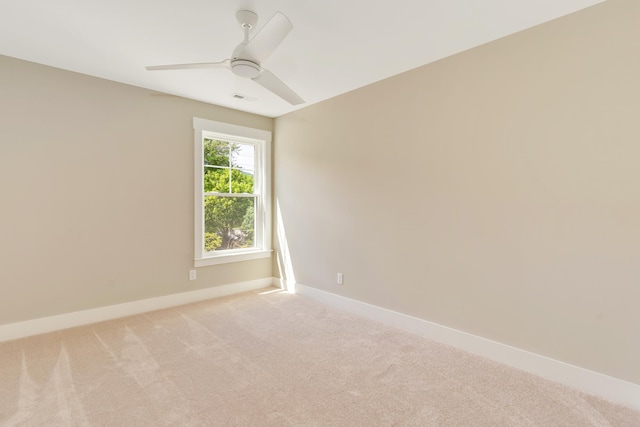 unfurnished room featuring light carpet, baseboards, visible vents, and a ceiling fan