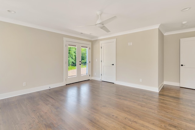 empty room featuring ornamental molding, french doors, baseboards, and wood finished floors