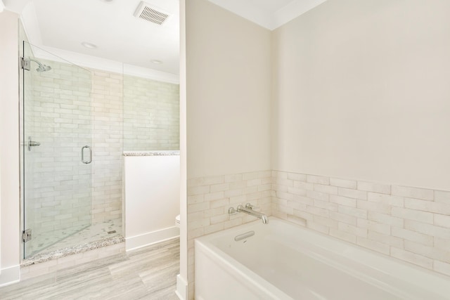 bathroom featuring hardwood / wood-style floors, toilet, shower with separate bathtub, and tile walls