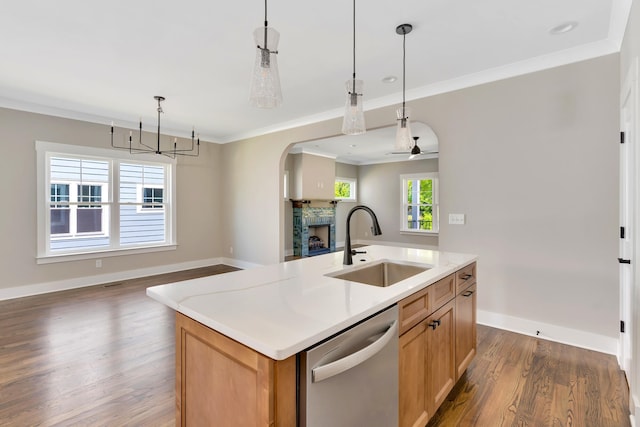 kitchen featuring pendant lighting, a center island with sink, stainless steel dishwasher, and sink