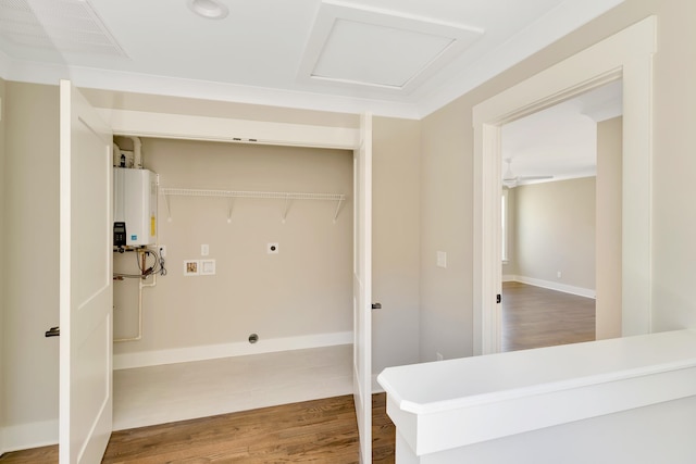 washroom featuring electric dryer hookup, tankless water heater, wood-type flooring, and washer hookup