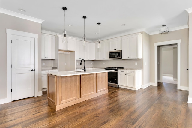 kitchen with stainless steel appliances, light countertops, crown molding, and a sink