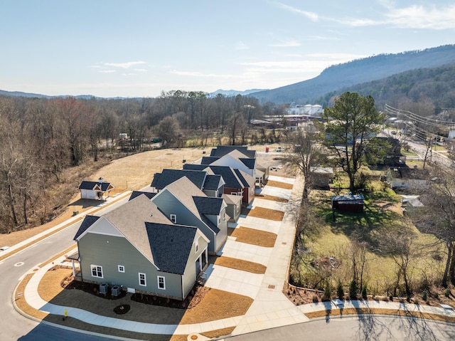 birds eye view of property with a forest view and a mountain view