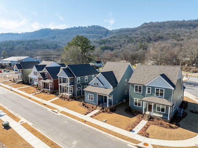 aerial view with a mountain view, a forest view, and a residential view