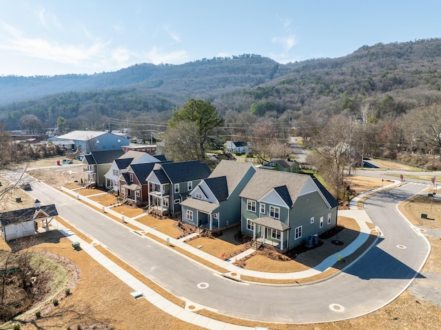 birds eye view of property with a mountain view and a forest view