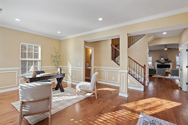 home office featuring hardwood / wood-style flooring, ceiling fan, and crown molding