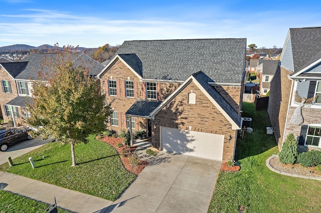 view of front facade featuring a front yard and a garage