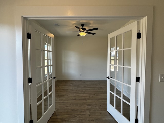 unfurnished room with ceiling fan, dark hardwood / wood-style flooring, and french doors