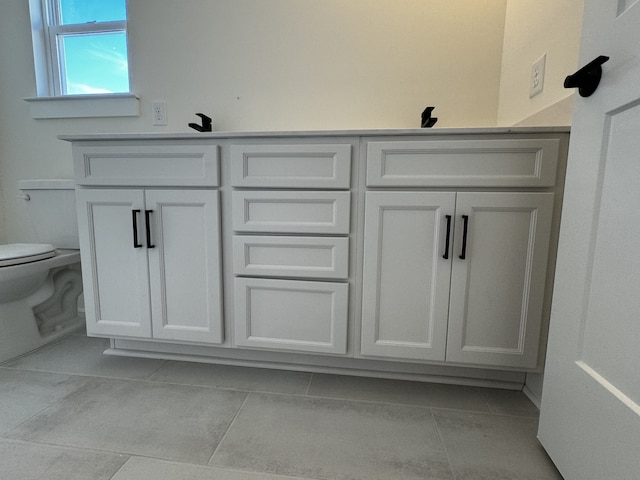 bathroom with tile patterned floors and toilet