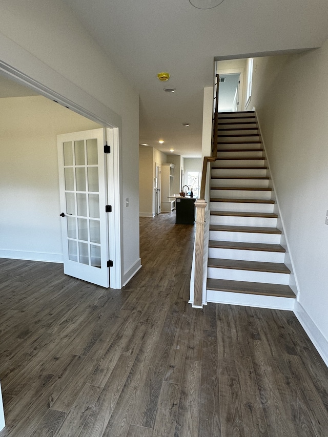 staircase with hardwood / wood-style floors